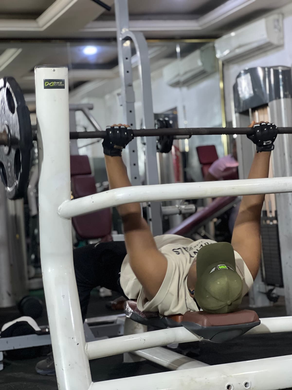 Member bench pressing at X-Fitness Gym