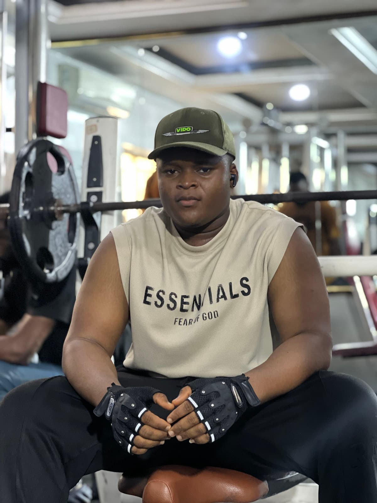 X-Fitness Gym member taking a break between sets